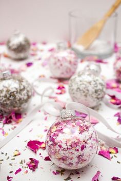 pink and white ornaments on a table with confetti