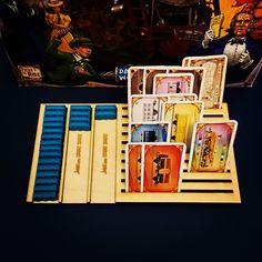 a box with some cards in it on a table next to a toy train and figurines