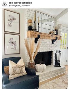 a living room filled with furniture and a fire place in front of a brick fireplace