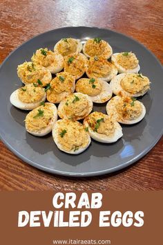 crab deviled eggs on a blue plate with parsley sprinkled on top