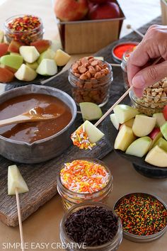 an assortment of fruits, nuts and dips on a table