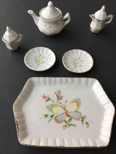 Butterfly pattern Gold trim This set was purchased at an estate sale Approximate measurements: Tray 3.74” x 2.75” Plates 1.25” Teapot is 2” tall with lid Please see photos Thank you for looking Miniature Tea Set China Porcelain Vintage Butterfly 9 Pieces Unmarked. Condition is "Used". Shipped with USPS Porcelain Vintage, Miniature Tea Set, Vintage Butterfly, Butterfly Pattern, China Porcelain, Gold Trim, Tea Set, Estate Sale, Tea Pots