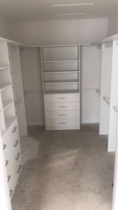 an empty walk in closet with shelves and drawers