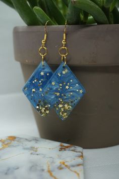 Blue Star Charm Dangle Earrings, Blue Dangle Earrings With Star Charm, Blue Star Charm Earrings For Party, Blue Star Charm Earrings As Gift, Blue Star Charm Earrings For Gift, Blue Glitter Dangle Earrings, Blue Star Earrings With Star Charm, Resin Earrings, Diamond Shaped