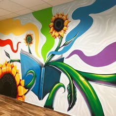 a colorful mural in an office with sunflowers painted on the wall and books