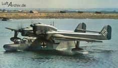 an old airplane is floating in the water