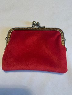 a red purse sitting on top of a white table