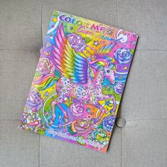 a colorful coloring book sitting on top of a gray surface