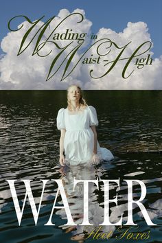 a woman standing in the water with clouds above her