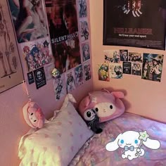 a bedroom with posters and stuffed animals on the wall