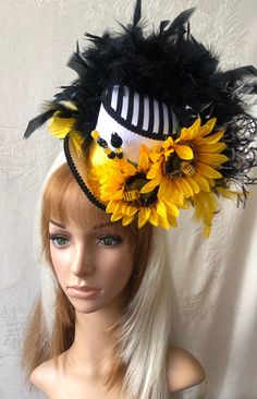 "I love bees so naturally, I love this hat. Cute little (sort of) realistic bees landed on some sunny yellow sunflowers. Cute hat for any sunny event. See this listing for how my hats go on. https://www.etsy.com/listing/186224360/example-and-demonstration-of-how-my-hats?ref=shop_home_active_23 -------------------------------------------------------------------------------- It measures 4 1/2\" high by 6\" x 6\" wide at the base. This is considered a \"medium\" sized hat in Chiki Bird Hat Studio. Whimsical Adjustable Hats For Carnival, Whimsical Adjustable Hat For Carnival, Whimsical Mini Hats For Carnival And Kentucky Derby, Spring Novelty Hats With Curved Brim, Spring Novelty Hat With Curved Brim, Adjustable Mini Hats For Summer Carnival, Fun Curved Brim Hat For Kentucky Derby, Novelty Curved Brim Hat For Spring, Whimsical Adjustable Mini Hats For Carnival