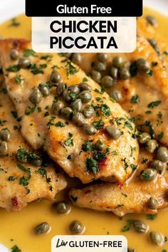 two pieces of chicken with capers and mustard sauce on a white plate, ready to be eaten