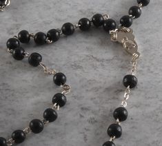 "For sale is a vintage rosary beaded cross necklace. This necklace is silver tone metal with black plastic beads a cross pendant and Mary & Jesus on the center pendant. The cross is signed Italy and measures 3/4 x 1 1/4\". The rosary chain measures 18\" with a 3\" drop. New Treasures added all the time. Check back often!" Silver Rosary With Black Beads And Crucifix, Straw Placemats, Festival Necklace, Metal Fish, Beaded Cross, Rosary Chain, Rosary Beads, Silver Accessories, Plastic Beads