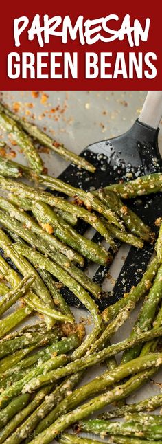 cooked green beans on a spatula with parmesan sprinkles and seasoning