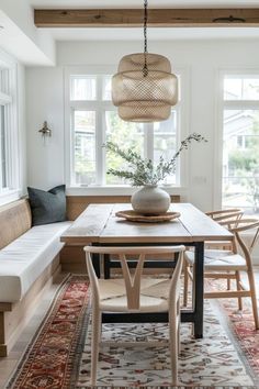 a dining room table with chairs and a bench