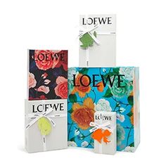 three bags with different designs on them and the words loewe written in black