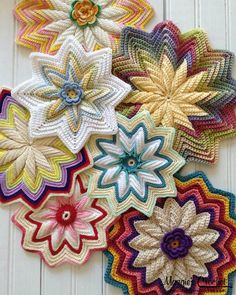 crocheted flowers are arranged on a white surface