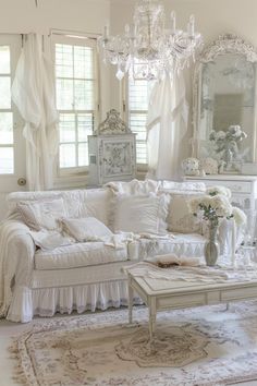 a living room filled with furniture and a chandelier