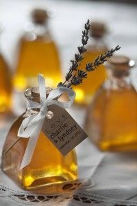 several small bottles filled with different types of liquid and some lavender sprigs in them