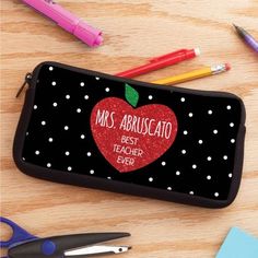 Transporting pens and school supplies is made easy and stylish with a personalized pencil case! Featuring a black and white polka dot background, this fashionable case makes a great gif for the special teacher in your life! Best teacher ever automatically appears. Personalize with a name or title along the top. Size: 8 inch x 4 inch. Color: Red. Black Stationery For Back To School, Black Pencil Shaped Stationery With Zipper Pouch, Black Pencil Stationery For School, Black Zipper Pencil Pouch Stationery, Black Pencil Case For Back To School, Black Pencil-shaped Stationery With Zipper Pouch, Black Zipper Pouch Stationery For School, Black Pencil Case For Back To School Gift, Black Pencil Stationery For Personal Use