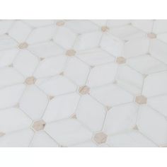 a close up view of the white and beige hexagonal pattern on this tile