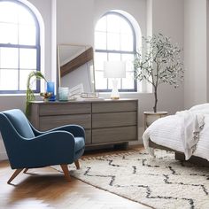 a bedroom with a bed, chair and dresser in it's centerpieces