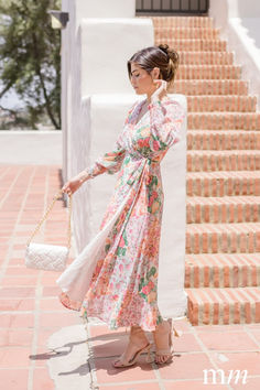 Indulge in the femininity of the Sheena Midi Dress. Embrace the beautiful blush floral print and elegant wrap style side tie closure. The long sleeves with elastic cuffs add a touch of sophistication while the flowy skirt brings effortless movement to your look. Perfect for any occasion. Floral Print Design, Floral Print Midi Dress, Print Midi Dress