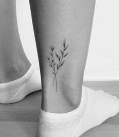 a black and white photo of a plant on the ankle