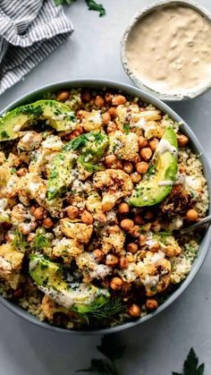 a bowl filled with cauliflower, chickpeas and avocado