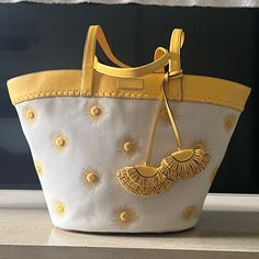 This Adorable Beach Bag Is Hard To Let Go Of Because It’s So Cuuuuute. Beautiful Sun Embroidered Tote Perfect For Warm Weather And Coastal Outings. New With Tags But They Are Tucked In The Pocket Because They Were Unattached When I Purchased The Bag Gold-Plated Hardware Open Top Tie Closure Interior Zip Pocket & Slip Pocket Approx. 12.5" X 20.5" X 6.4" Bag; 11.5" Handle Drop Yellow Top Handle Shoulder Bag For Beach, Yellow Top Handle Shoulder Bag For Vacation, Luxury Yellow Bag With Braided Handles, Luxury Yellow Bags With Braided Handles, Kate Spade Summer Shopping Bag, Spring Yellow Shoulder Bag With Leather Handles, Yellow Leather Handle Shoulder Bag For Spring, Luxury Yellow Shoulder Bag With Braided Handles, Luxury Yellow Shoulder Bag For Summer