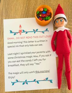 an elf with a bowl of candy next to a sign that says shh, do not read this out loud