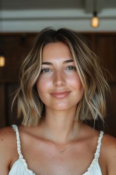 Smiling woman with shoulder-length hair and a white top in softly lit indoor setting. Bobs Haircuts For Thick Hair, Choppy Bob Hairstyles Curtain Bangs, Fine Hair Haircuts Round Face, Bob Hairstyle With Highlights, Best Haircut Round Face, Textured Bob Haircut With Curtain Bangs, Long Bob With Curtain Bangs Round Face, Choppy Bob Round Face, Long Bob Haircuts For Fine Hair