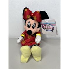 a mickey mouse stuffed animal sitting on top of a table