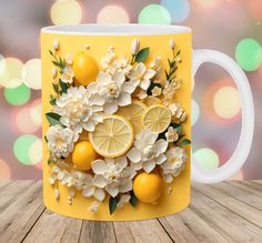 a coffee mug with lemons and flowers on the inside is sitting on a wooden table