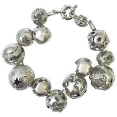 For Sale on 1stDibs - This bracelet by Gianni Versace is rare with it's unique detailing of balls with different cut-out patterns. The silver tone complements beautifully against Modern Silver Bracelets With Silver Beads, Luxury Silver Bracelets With Polished Beads, Modern Silver Bracelet With Silver Beads, Luxury Silver Bracelets With Silver Beads, Luxury Silver Beaded Bracelets For Party, Luxury Silver Jewelry With Polished Beads, Silver Metal Beaded Bracelets, Modern Silver Beaded Bracelets For Jewelry Making, Silver Polished Metal Beads Jewelry