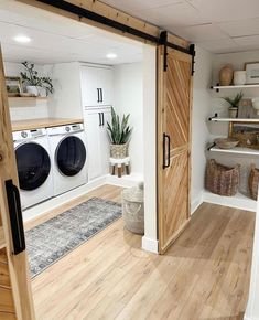 an open door leading to a washer and dryer in a room with wooden floors