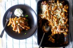 a casserole dish with meat and cheese on the side next to a fork