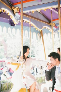 a man and woman on a merry go round ride