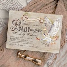 an old fashioned baby shower is displayed on top of a blanket with a pen in it