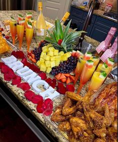 a table topped with lots of different types of food and drinks on top of it