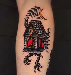 a tattoo on the leg of a person with a bird and house in front of it