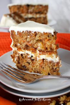 a slice of carrot cake with white frosting on a purple and white polka dot plate