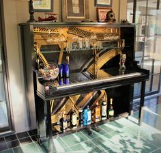 there is a piano that has many bottles on it