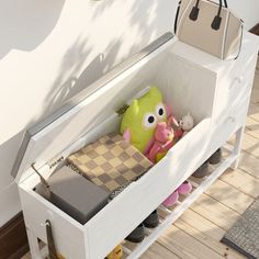 a white bench with stuffed animals and purses in it on the floor next to a wall