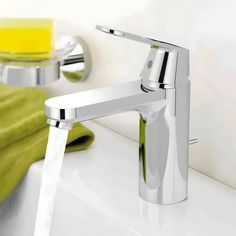 a chrome faucet with water running from it