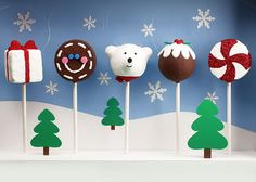 there are many christmas themed lollipops on the stick