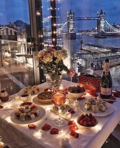 a table topped with plates of food next to a window