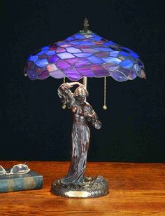 a table lamp with a woman holding an umbrella