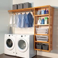 a washer and dryer sitting next to each other in front of a wooden shelf