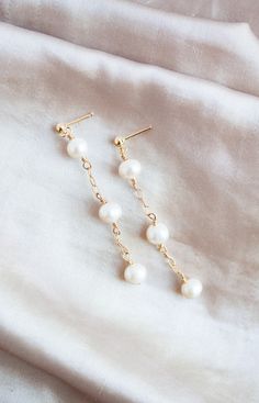 This listing is for a pair of freshwater pearl and 14k gold filled earrings. All gold accessories are 14k gold filled. The white freshwater pearls measure 6 mm. The earrings are 2 inches long. Perfect for everyday wear, weddings, gifts, and more! Please check out the matching freshwater pearl and 14k gold filled necklace here -https://wildcollections.etsy.com/listing/668016373  Please check out the matching freshwater pearl and 14k gold filled bracelet here -  https://wildcollections.etsy.com/listing/649806865 14k Gold Filled Pearl Drop Earrings For Anniversary, 14k Gold Hypoallergenic Drop Pearl Earrings, Anniversary 14k Gold Filled Pearl Drop Earrings, 14k Gold-filled Pearl Charm Earrings For Anniversary, 14k Gold Filled Pearl Charm Earrings For Anniversary, Pearl White Drop Pearl Earrings In 14k Gold Filled, 14k Gold-filled Pearl White Drop Earrings, 14k Gold Filled Pearl White Dangle Pearl Earrings, Pearl White 14k Gold Filled Drop Earrings